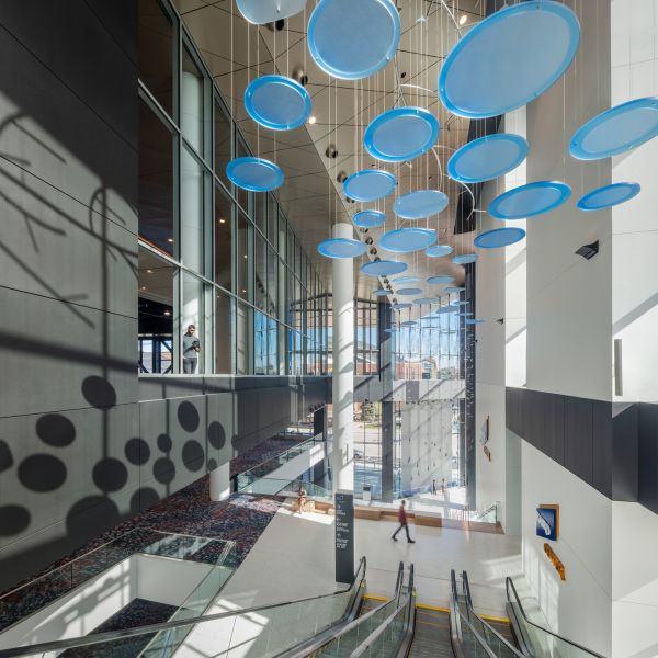Interior of Baird Center showcasing an art installation above escalators