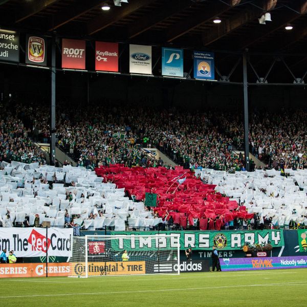 Portland Timbers fans holding red and white flags