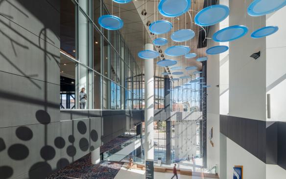 Interior of Baird Center showcasing an art installation above escalators