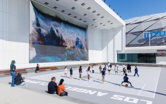Public basketball court in the outdoor plaza at Intuit Dome