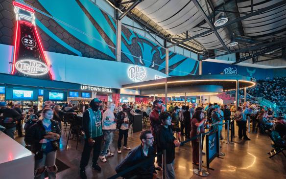 Basketball fans in the Dr. Pepper Pavillion during a Charlotte Hornets game at Spectrum Center