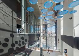Interior of Baird Center showcasing an art installation above escalators